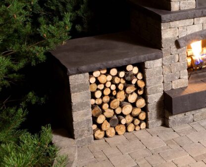Close-up of cut wood stored in the side of a Quarry Stone Fireplace by Barkman Concrete. Available at Ron Paul Garden Centre.